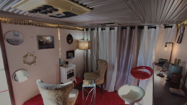 The actual lounge layout, with vintage chairs, curtains, and warm lamps.